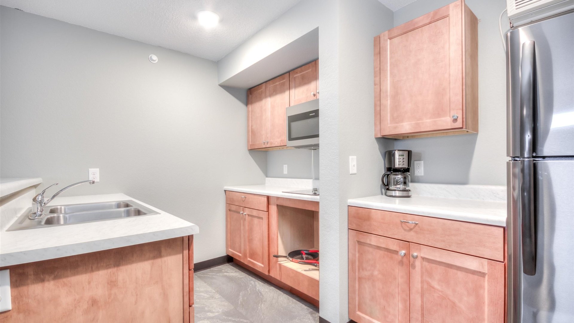 Sojourn suite kitchenette with cooktop and fridge
